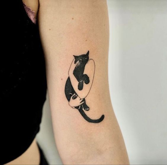 Fluffy black cat tattoo silhouette gazing at crescent moon