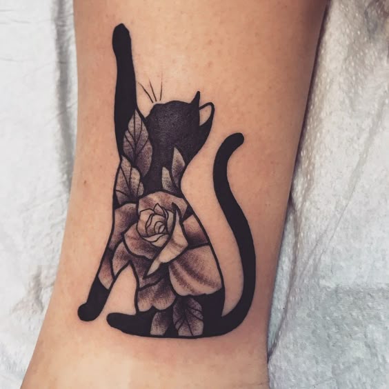 Minimalist black cat tattoo in memory of a pet
